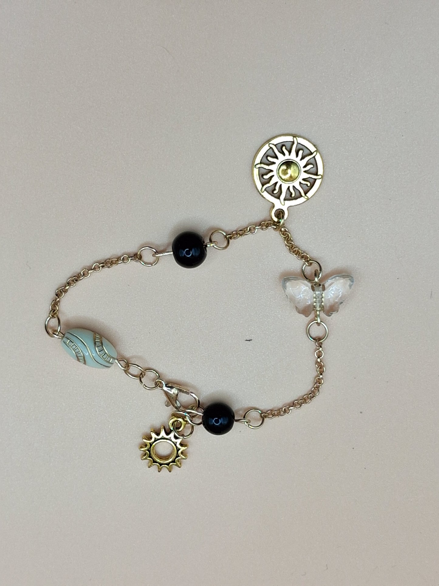 Gold-Toned Celestial Charm Bracelet with Sun Medallions & black Beads