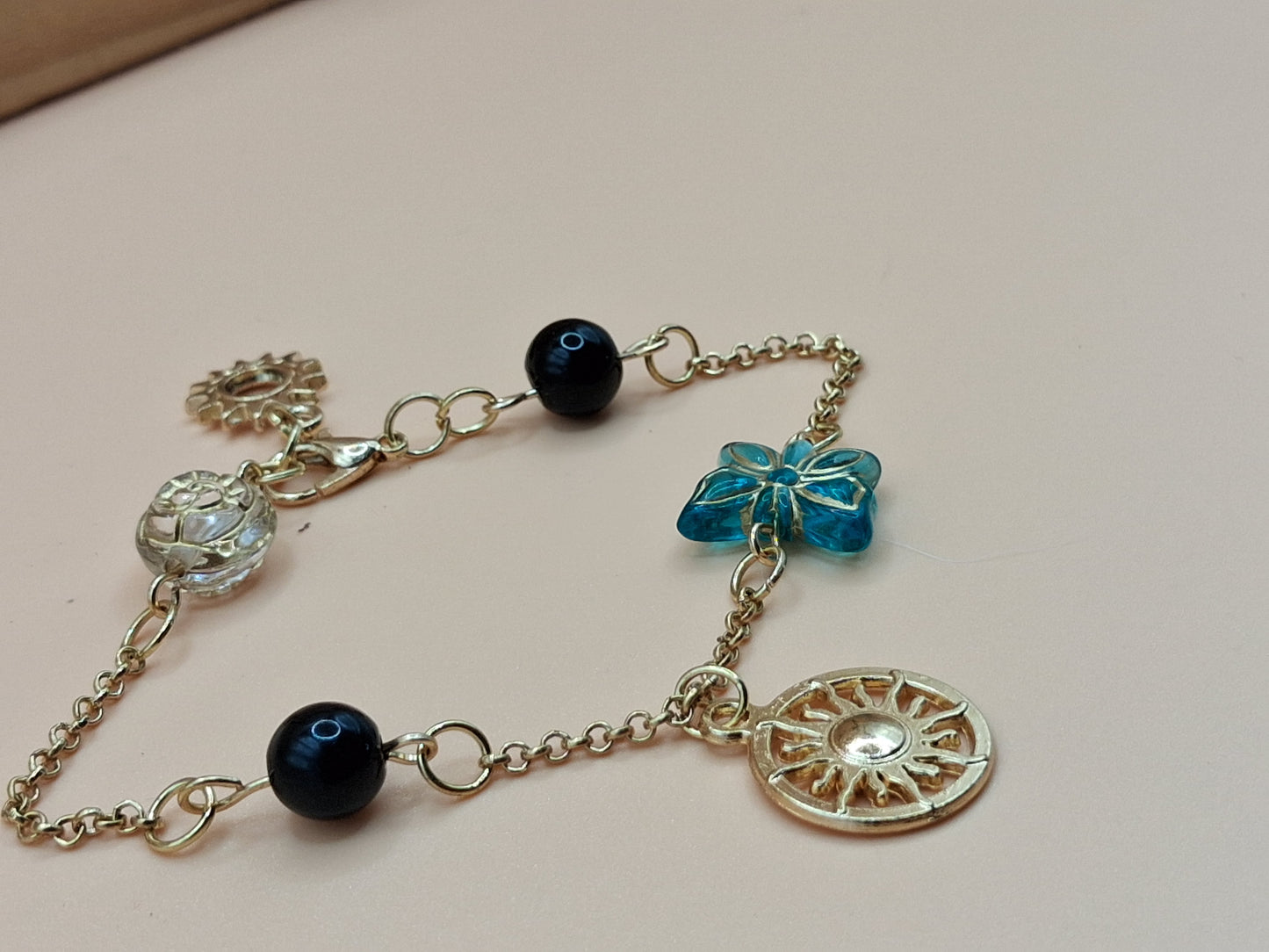 Gold-Toned Celestial Charm Bracelet with Sun Medallions & black Beads