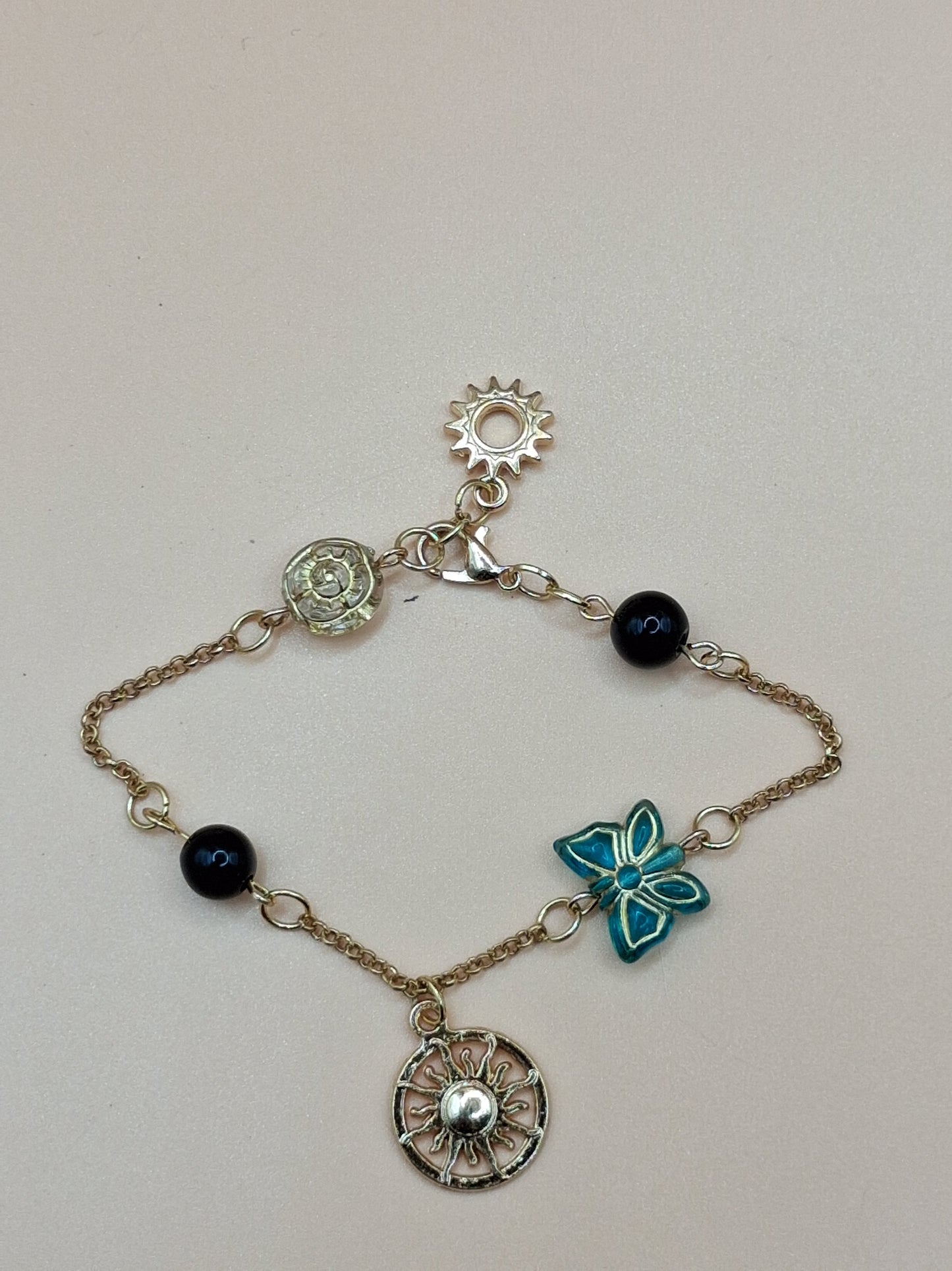 Gold-Toned Celestial Charm Bracelet with Sun Medallions & black Beads