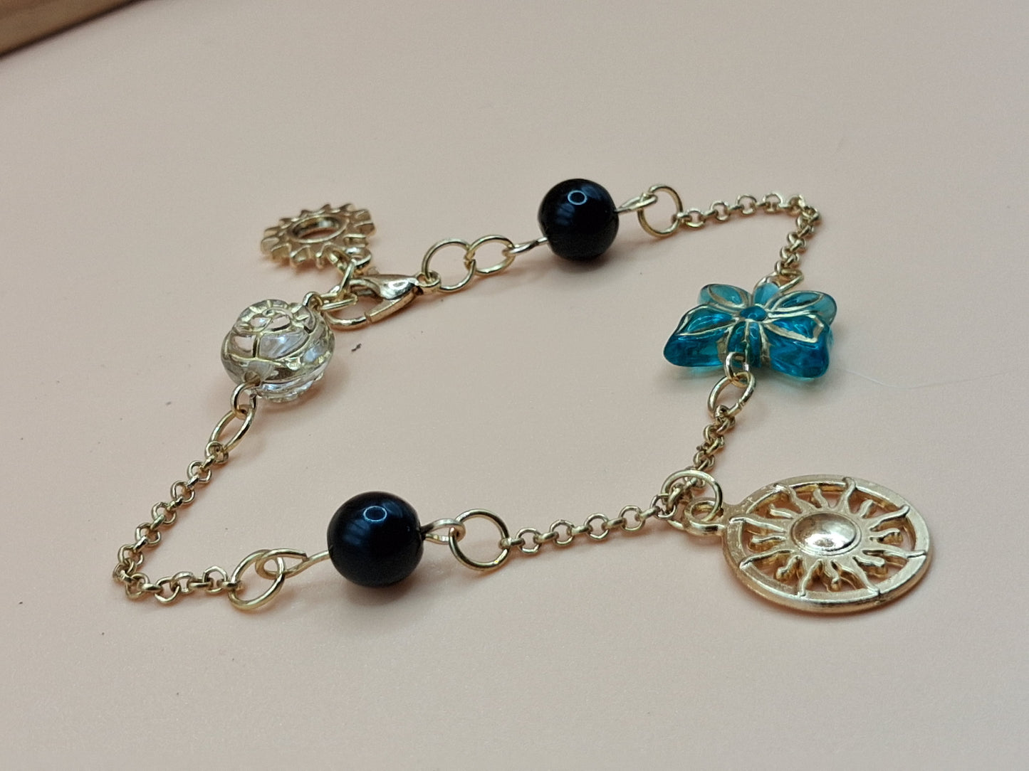 Gold-Toned Celestial Charm Bracelet with Sun Medallions & black Beads